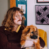 Colour medium close-up photograph of David Nance holding a dog