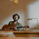 Colour photograph by Nick Helderman of José Gonzáles with an acoustic guitar