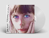 White vinyl version of Aquainted With Night by Lael Neale on Sub Pop Records (the album sleeve shows a close up grainy photograph of a sunlit Lael Neale looking at the camera with blue eyes; the artist name and album title is hand-written along the left edge)
