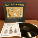 Packshot of The Secret Museum Of Mankind: Guitars Vol.1: Prologue To Modern Styles on Jalopy Records showing the album sleeve, record and the cover of the illustrated booklet
