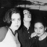 Black and white band photograph of Sleater Kinney featuring Corin Tucker, Carrie Brownstein, and Lori MacFarlane 
