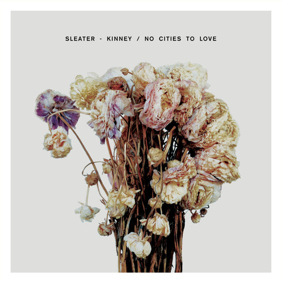 No Cities To Love by Sleater-Kinney on Sub Pop Records (the album cover is a colour photograph of a bunch of withering dead flowers against a grey background; the band name and album title appear above the flowers in small sans-serif uppercase text).